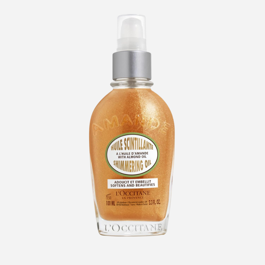 L'Occitane Almond Shimmering Body Oil clear glass bottle showing gold mica flakes